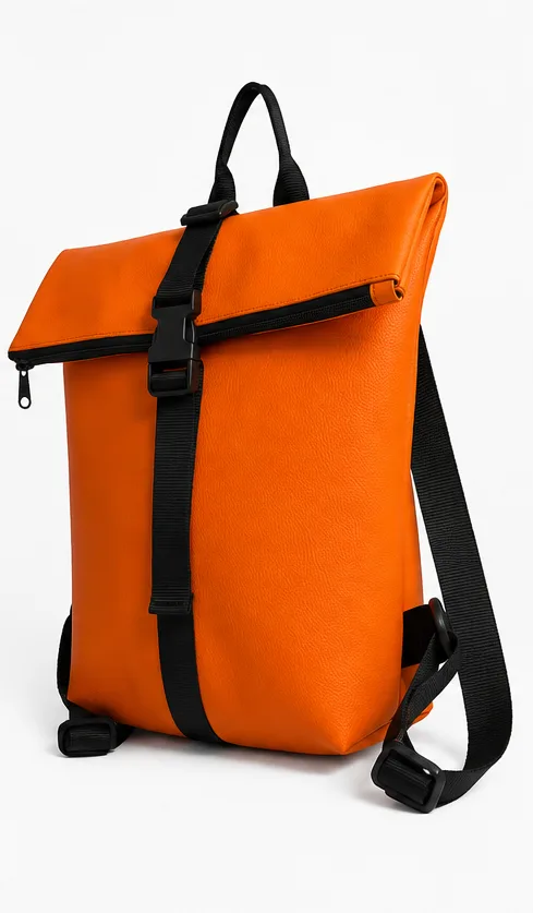 Three-quarter side view of the MOEL backpack showing the depth of the body and the roll-top closure folded over