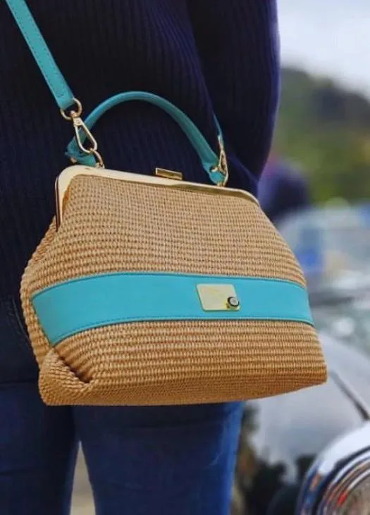 The Tiffany blue vintage bag by Monica Zuccheri carried over the shoulder in everyday use, outdoors